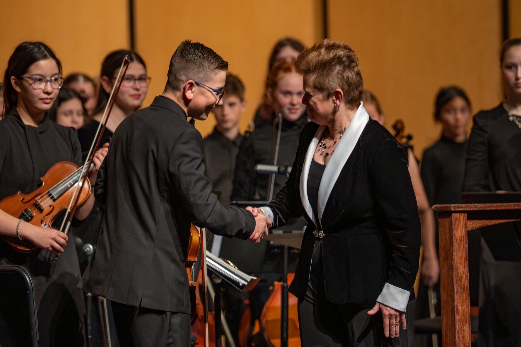 BPYO_Final_LRG_-12 A musician and conductor shake hands at a Boise Phil Youth Orchestra concert.