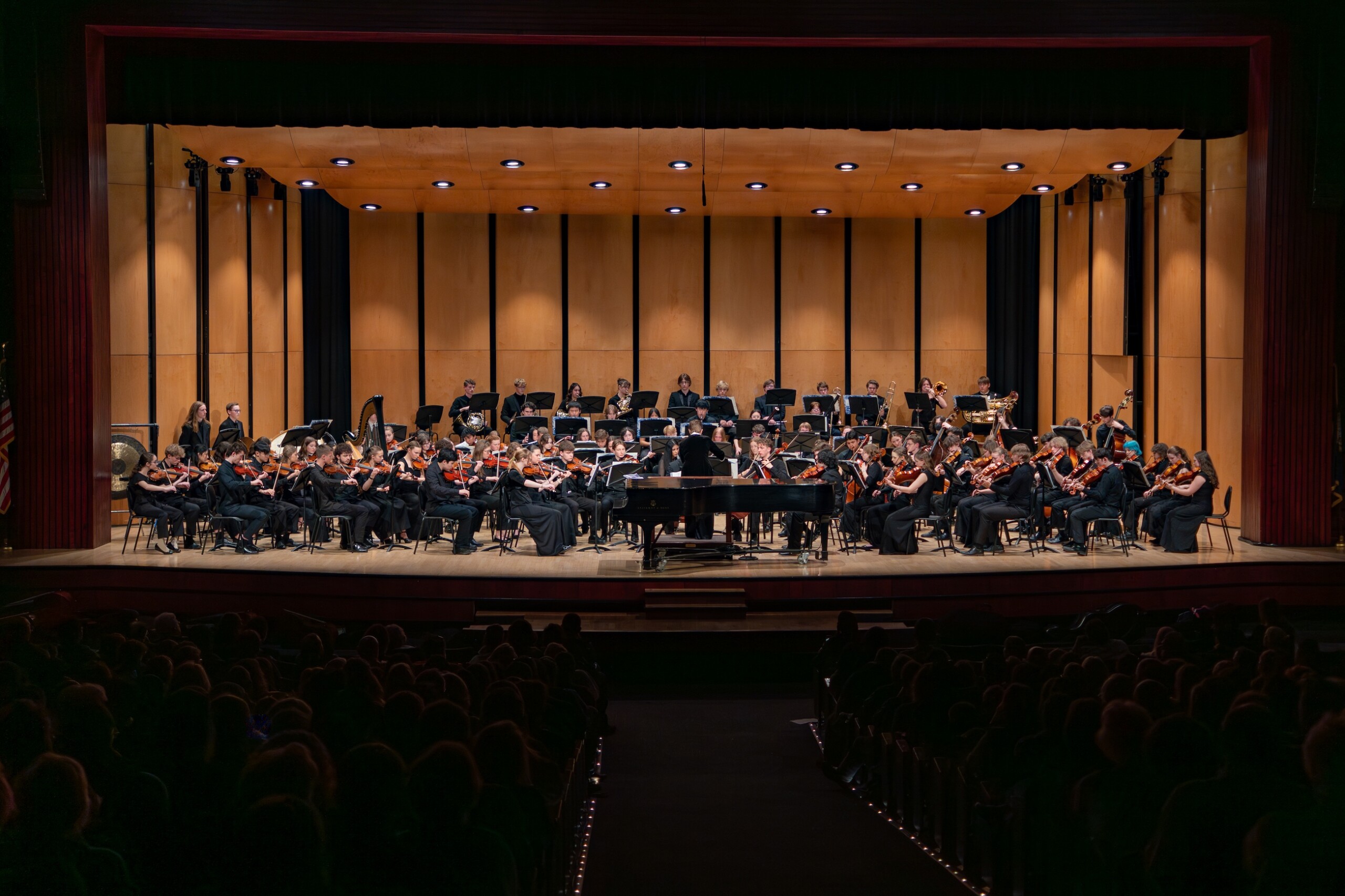 Boise Phil Youth Orchestra performs on stage with a grand piano.