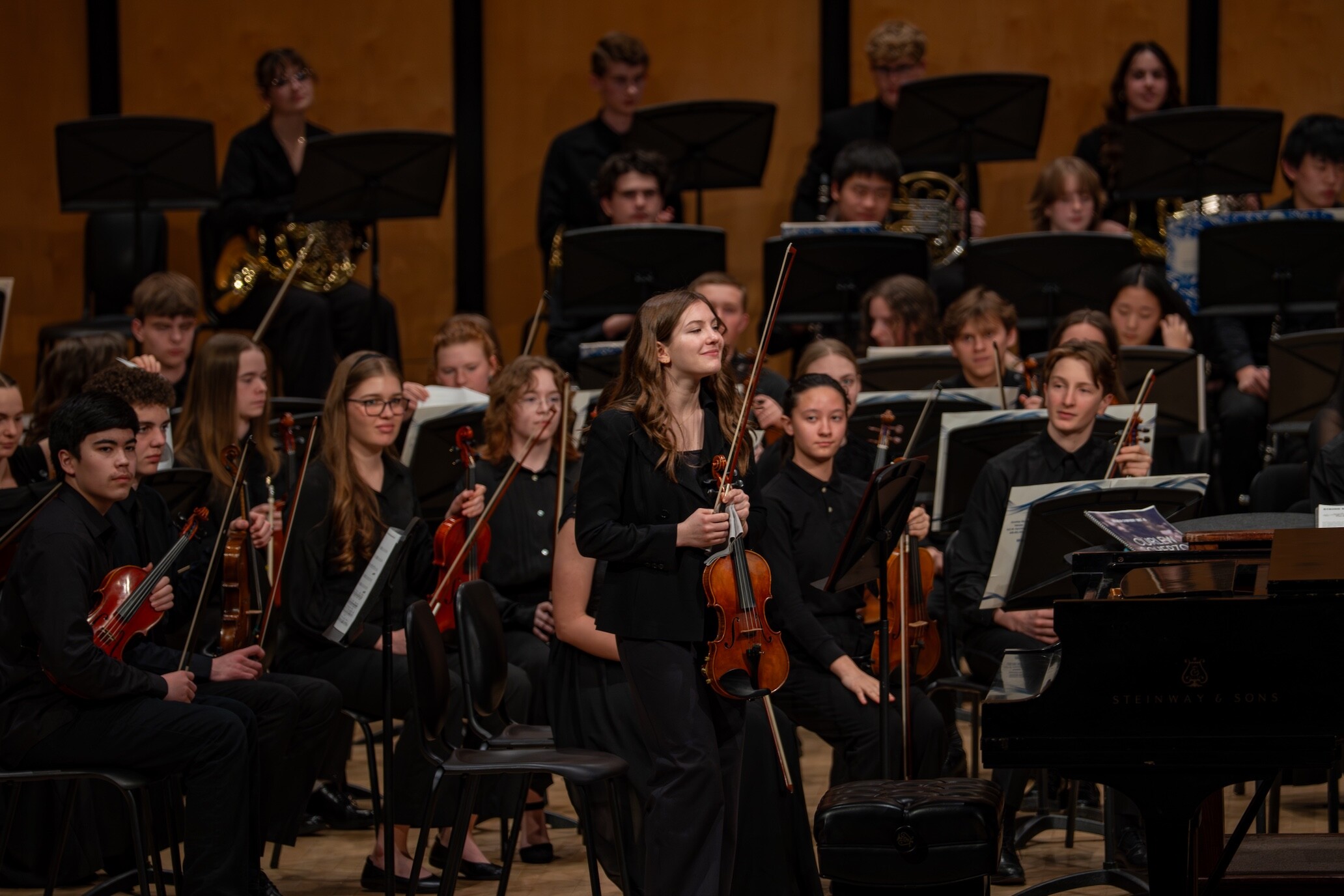 A young violinist stands during a Boise Phil Youth Orchestra performance.