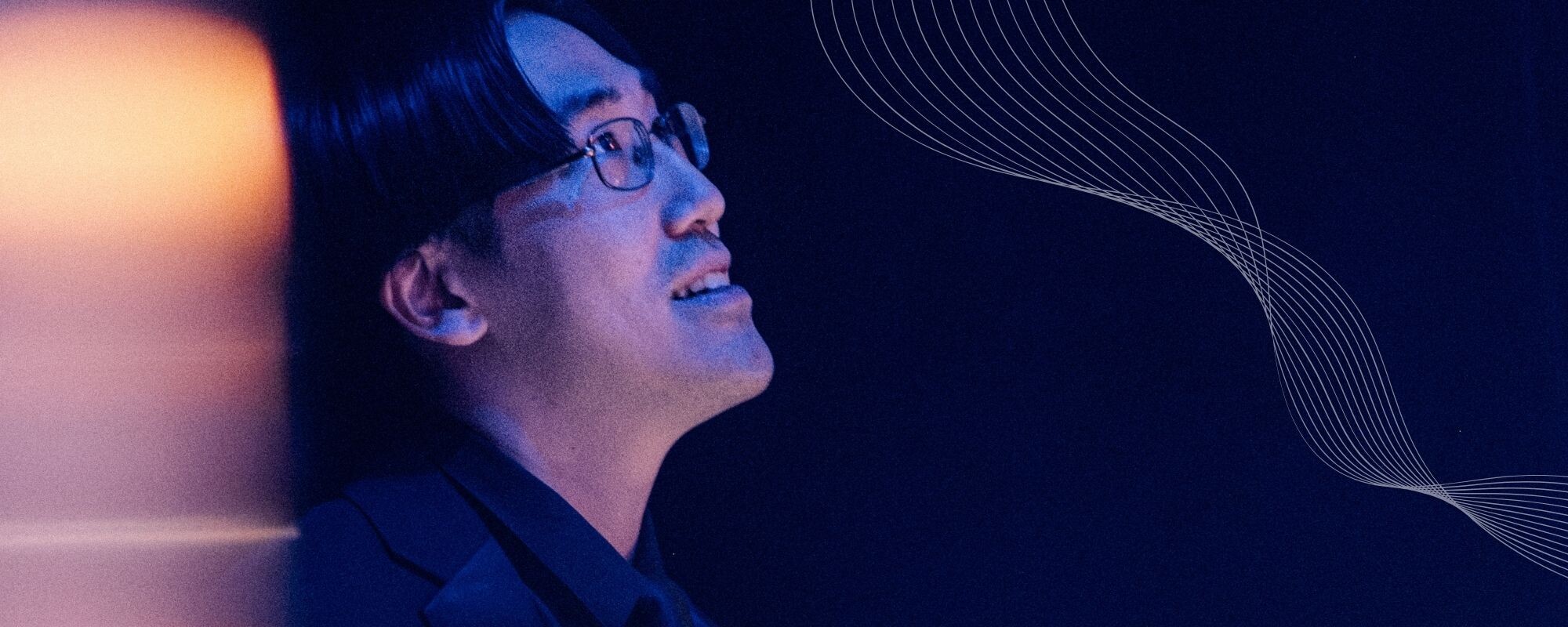 A Boise Phil musician performs under blue stage lighting.