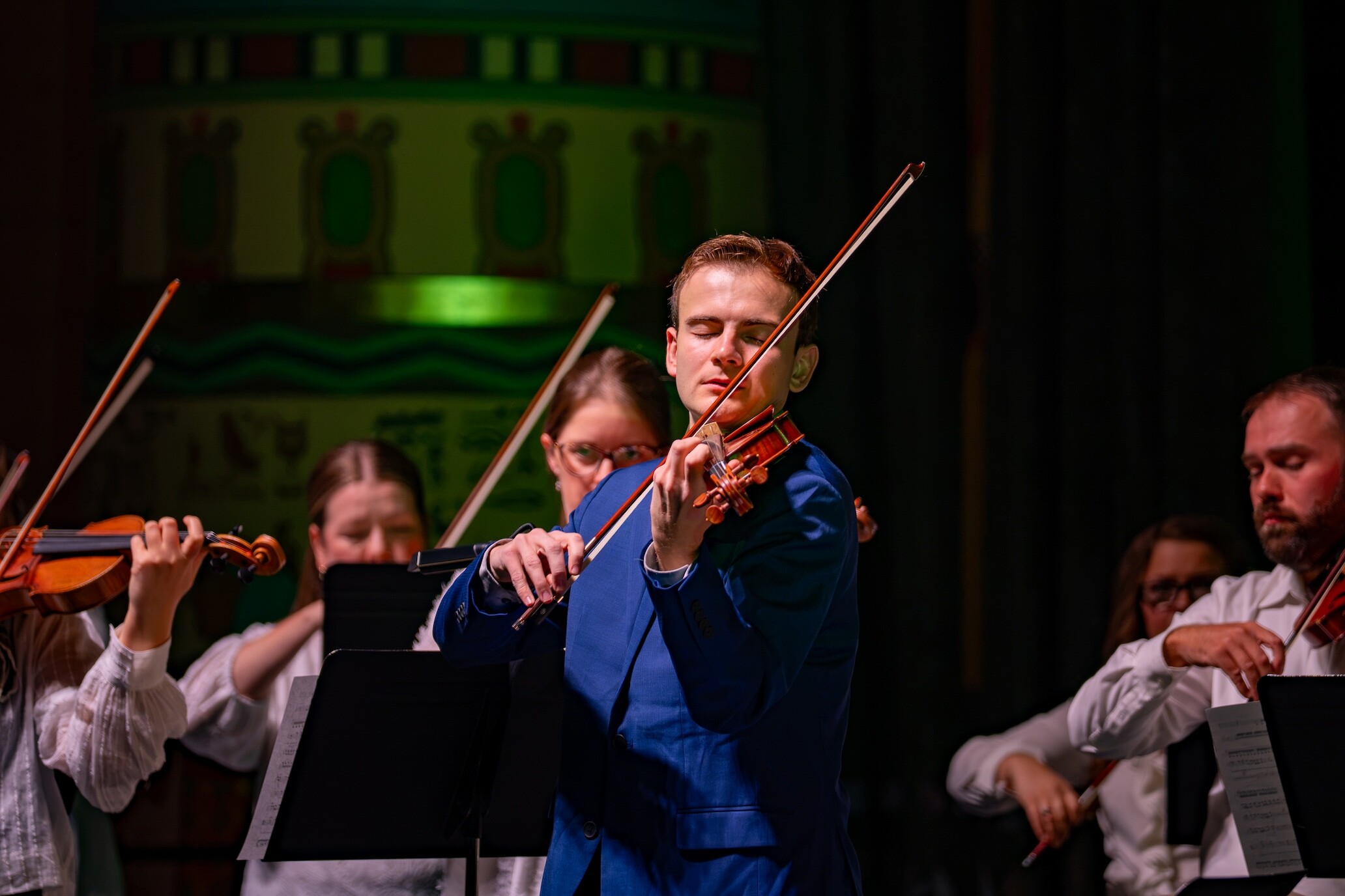 A violin soloist in a blue gown performs with Boise Phil.